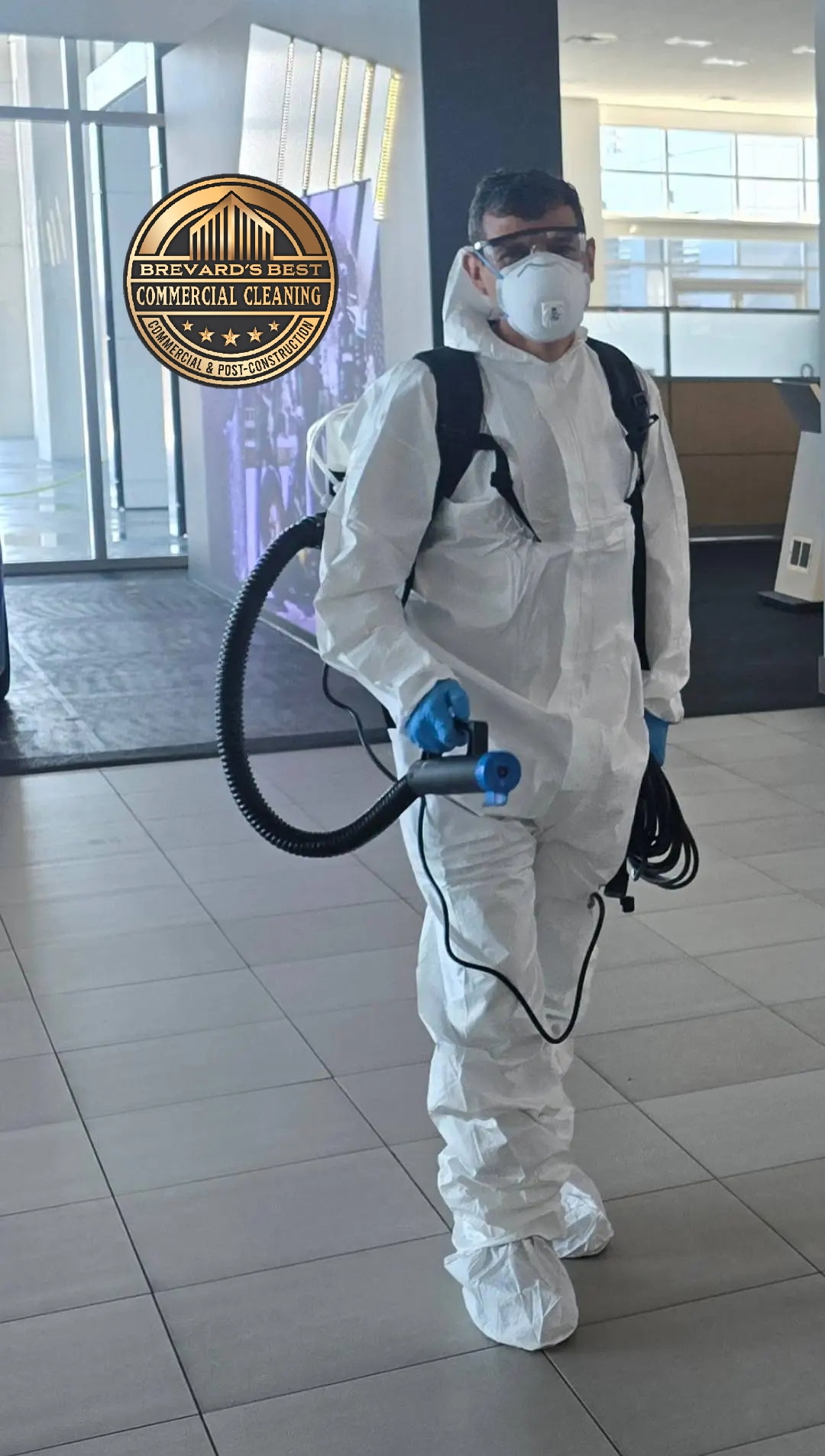 Worker in full PPE performing ULV disinfection fogging
